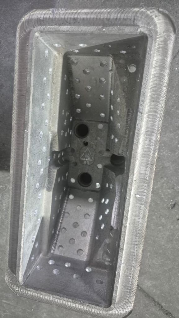 Final aluminium cast part inside its 3D printed pattern